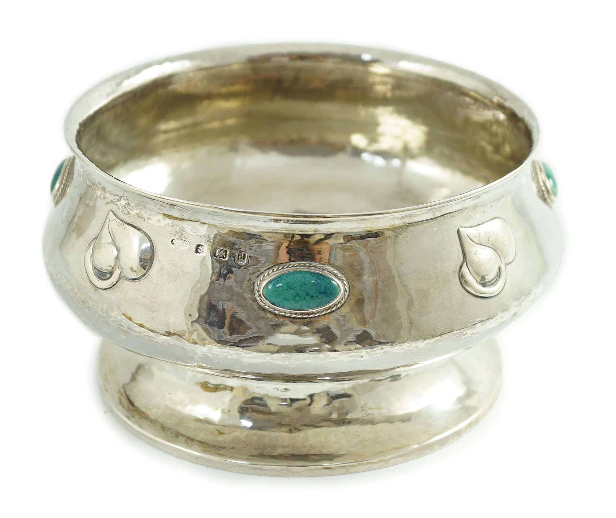 An Edwardian Art Nouveau silver pedestal bowl, inset with four oval Ruskin oval cabochons, by Albert Edward Jones